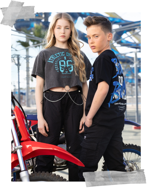 two kid models posing near bikes